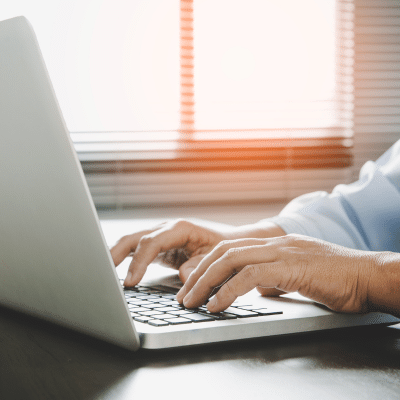 Closeup of a person typing on a laptop, representing the new medical center radiologists website