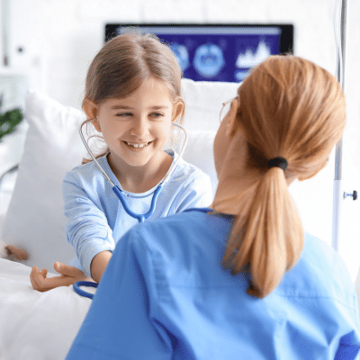Medical professional talking to a little girl in a hospital bed, representing mri for kids