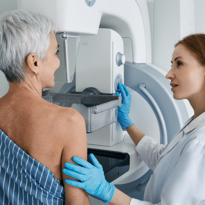Older woman getting advanced imaging done, representing early breast cancer detection
