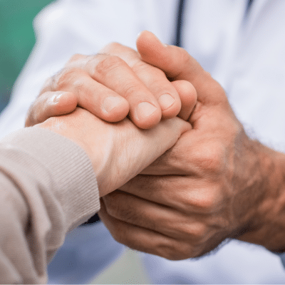 A doctor holding a patient's hand, representing cardiovascular disease detection