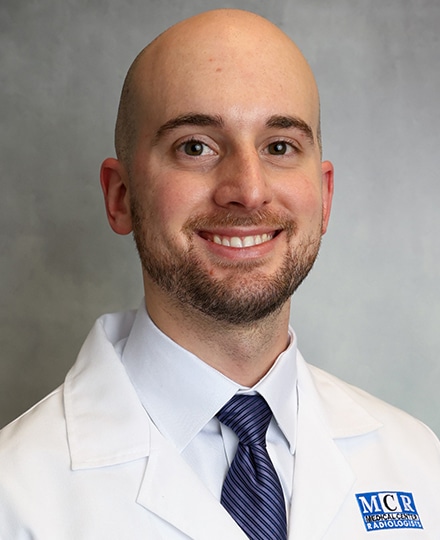 Andrew johnson, pa-c, ph. Professional headshot of a medical provider in a white coat and tie, smiling against a neutral gray background.