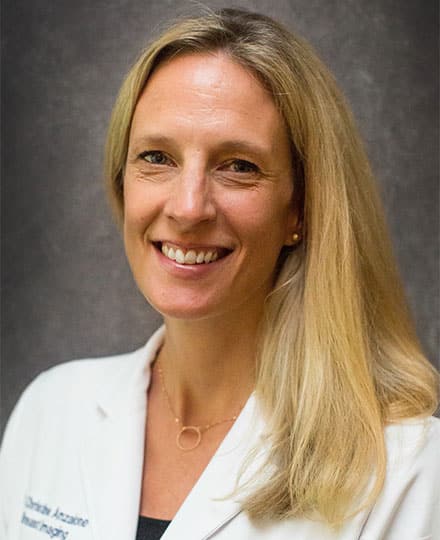 Christine anzalone, smiling female physician in a white medical coat posing for a professional headshot.