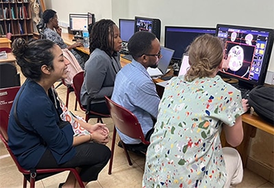 Radiologists reviewing ct scans together during rad-aid global health training in tanzania.