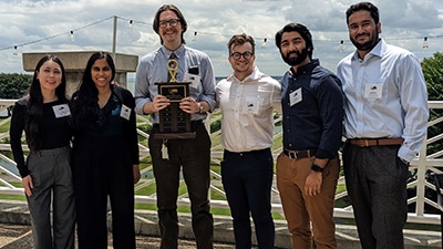 Evms radiology residents posing outdoors with an award at the vrs conference.