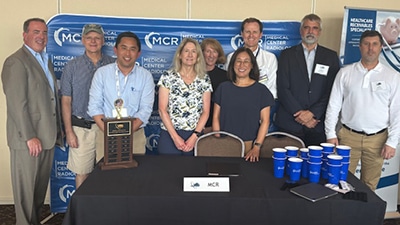 Evms radiology residents posing outdoors with an award at the vrs conference.
