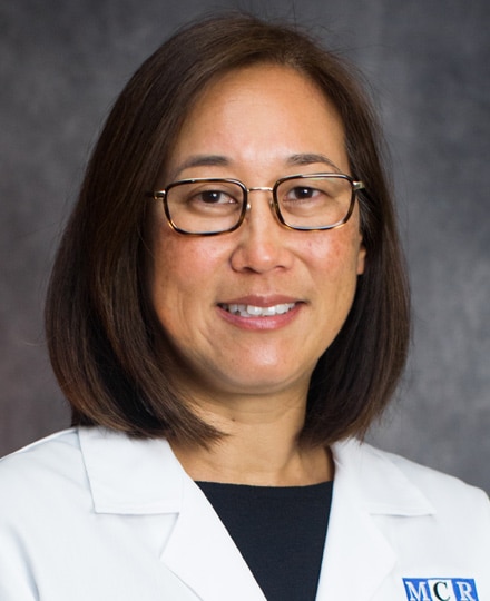 Meet dr. Kathy byun, md, pr. Professional headshot of a female radiologist wearing glasses and a white medical coat, smiling in front of a neutral studio background.