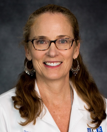 Meet dr. Kirstin davis, md. Professional headshot of a female radiologist wearing glasses and a white medical coat, posed against a neutral gray background.