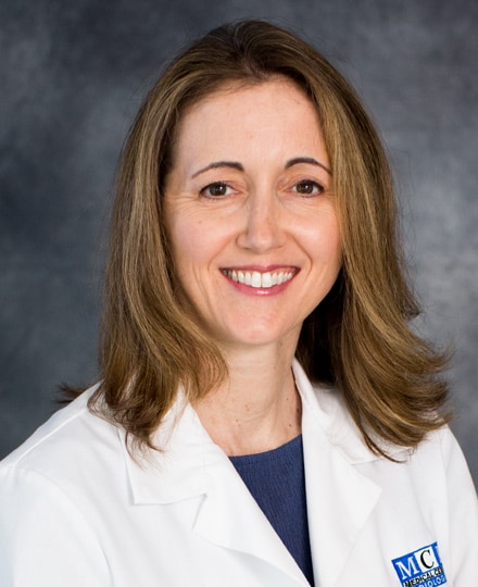 Lauren granata, md. Professional headshot of a female healthcare provider smiling against a gray backdrop.