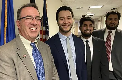 Mcr-and-evms-radiologists-attend-2024-acr-annual-meeting-img2 Group of medical center radiologists and evms radiology residents smiling together in a hallway during the 2024 acr annual meeting.