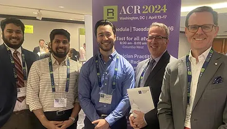 Mcr-and-evms-radiologists-attend-2024-acr-annual-meeting-img3 Group of radiologists and residents attending the 2024 acr annual meeting, standing together and smiling in front of an event banner.