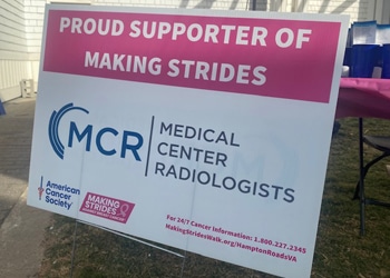 Sign displaying “proud supporter of making strides” with the medical center radiologists (mcr) logo at the american cancer society’s breast cancer awareness walk.