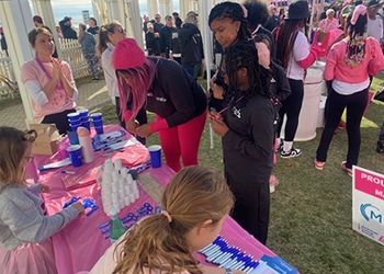 Children and adults at the making strides against breast cancer walk interacting at the medical center radiologists booth.