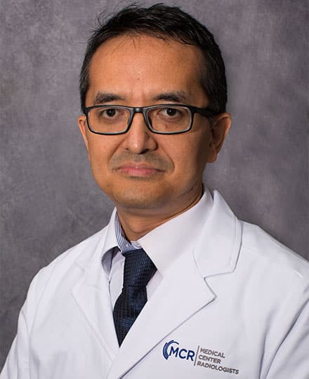 Meet dr swachchhanda songmen, your expert radiologist. Male radiologist wearing glasses and a white medical center radiologists lab coat, posing for a professional headshot.