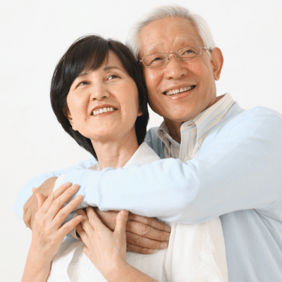 Older couple embracing in a warm pose, representing benefits of interventional radiology for men and women