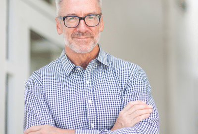 Older man with arms crossed, representing the question: what is bph in men?