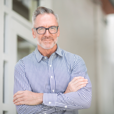 Older man with arms crossed, representing the question: what is bph in men?